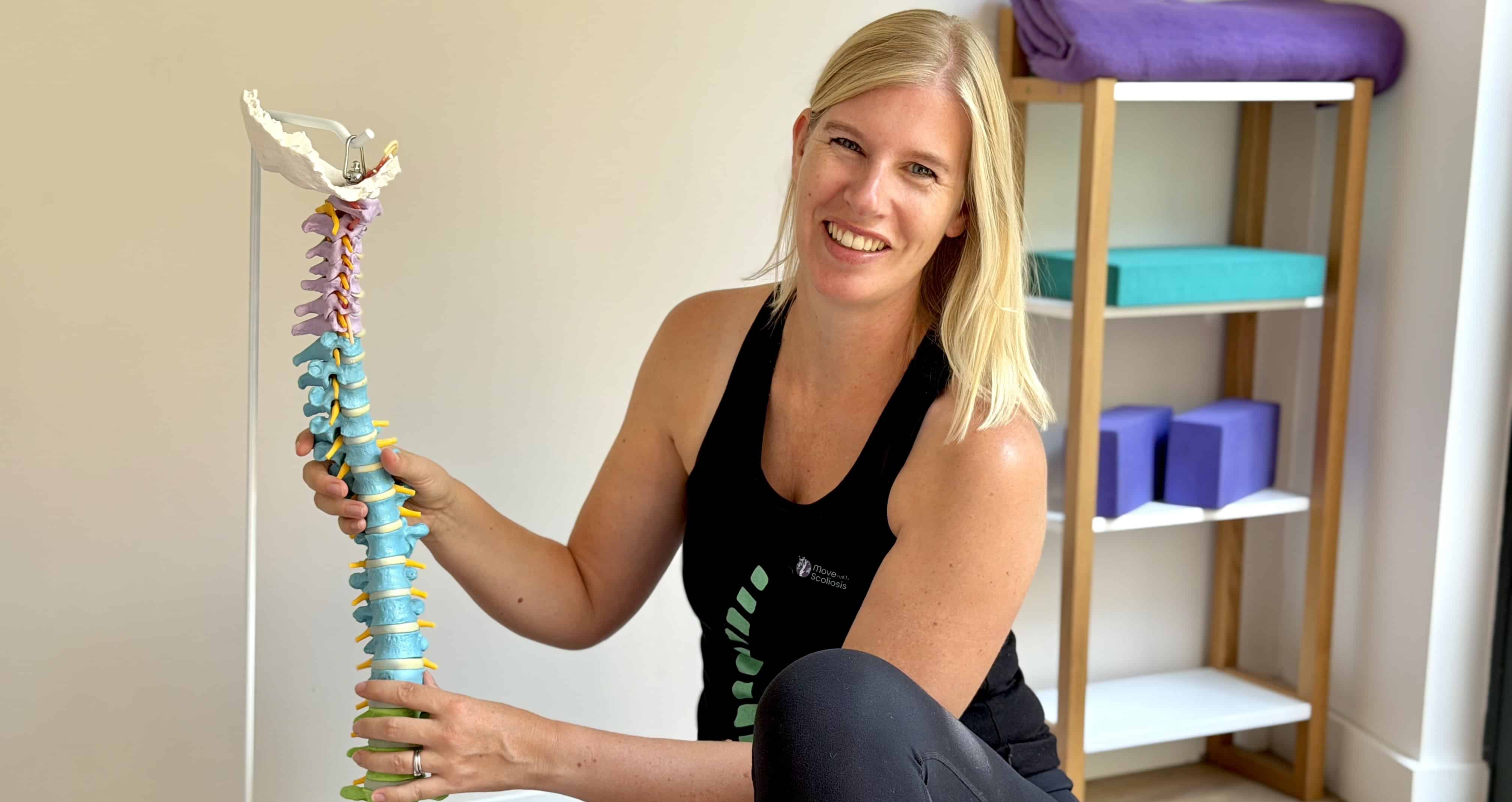 Christine Jaureguiberry Move With Scoliosis Christine holding spine model